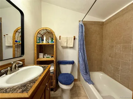 a bathroom with a sink toilet and a mirror