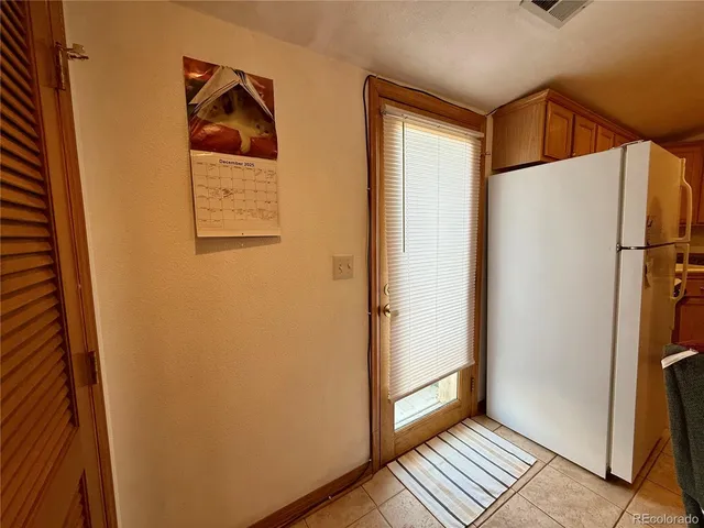 a view of front door and wooden floor