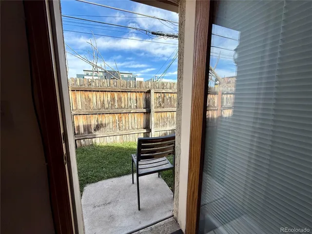 a view of a balcony with chairs and wooden floor