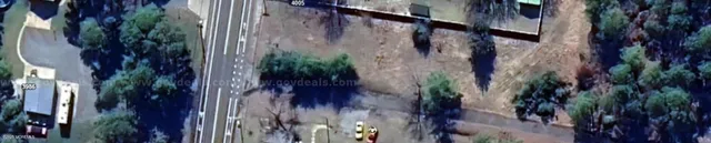 a view of a house with a plants and wooden wall
