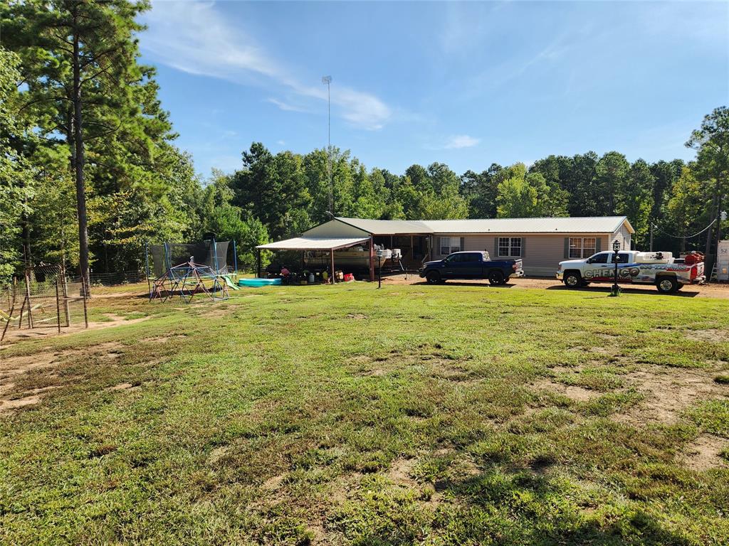 a view of a house with yard and sitting area