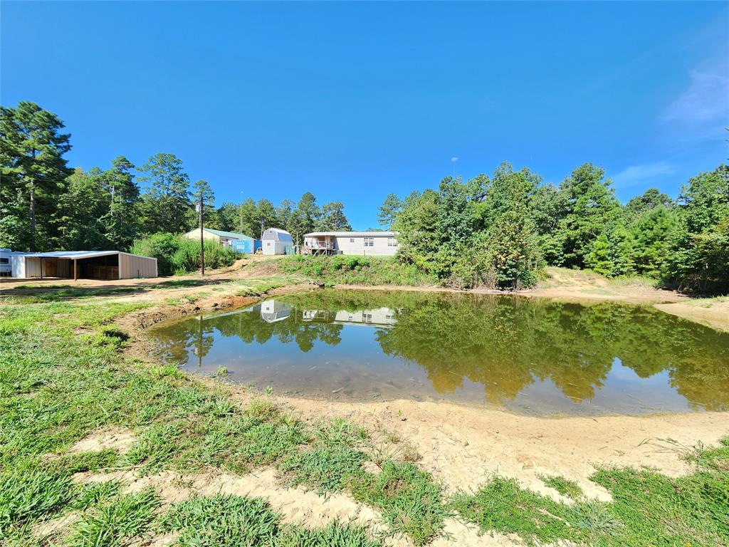 9937 County Road 3250 Timpson, TX 75975 - Photo 12 of 40 a view of a lake with a yard