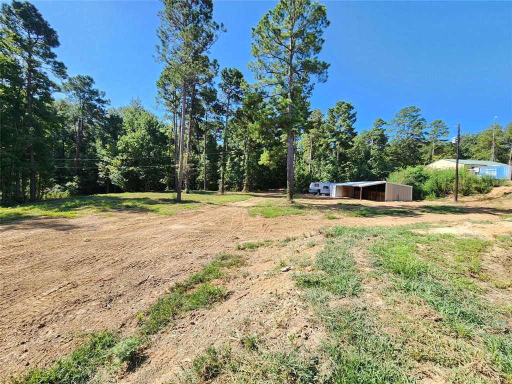 9937 County Road 3250 Timpson, TX 75975 - Photo 14 of 40 a house with trees in the background