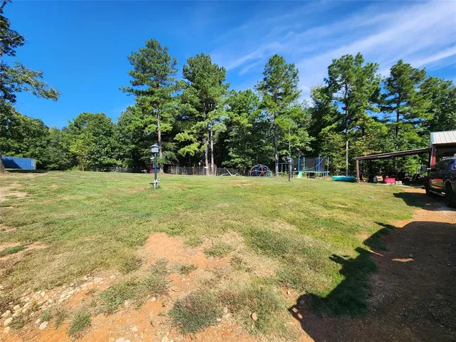 a swimming pool with trees in the background