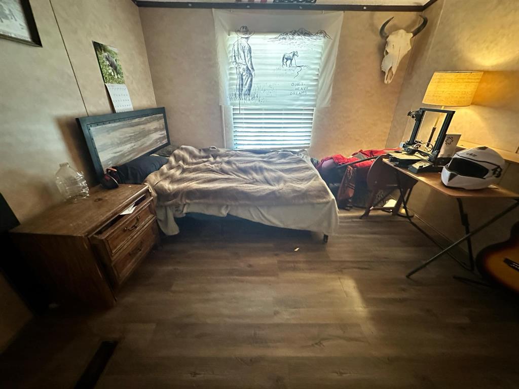 9937 County Road 3250 Timpson, TX 75975 - Photo 34 of 40 a bedroom with a bed next to a window