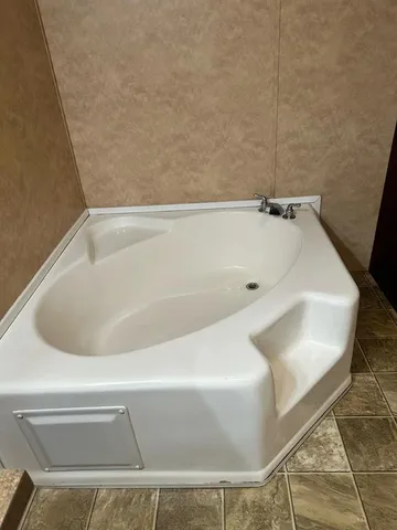 a bed sitting in a room next to a window