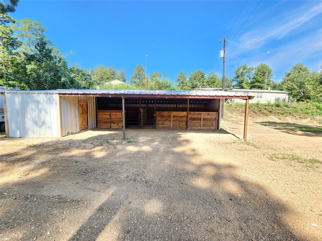 9937 County Road 3250 Timpson, TX 75975 - Photo 10 of 40 a view of a terrace with a bench
