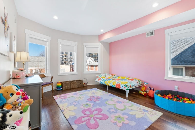 19 78th Street North Bergen, NJ 07047 - Photo 21 of 42 a bed room with furniture and a window