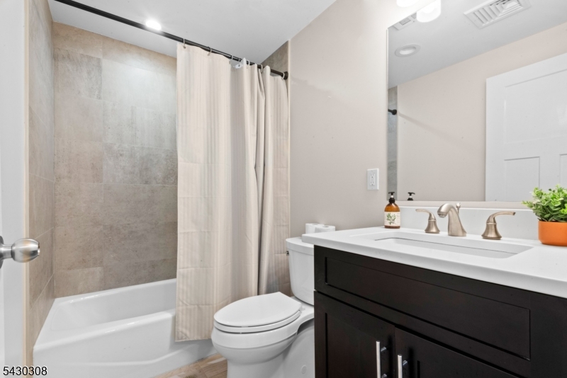 19 78th Street North Bergen, NJ 07047 - Photo 35 of 42 a bathroom with a sink and a mirror