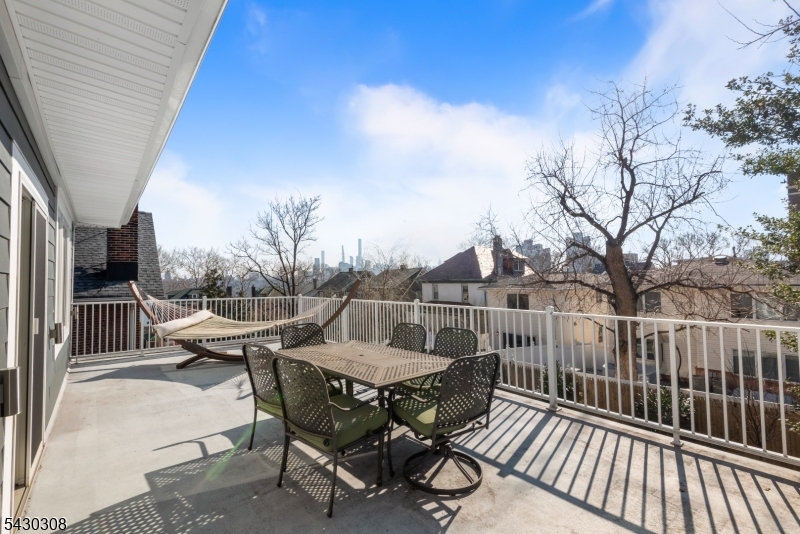 19 78th Street North Bergen, NJ 07047 - Photo 39 of 42 a view of a roof deck with wooden floor and fence