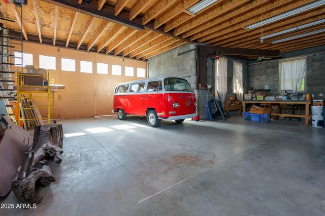 a backyard of a house with barbeque oven table and chairs