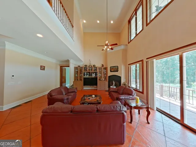 a living room with furniture and a floor to ceiling window