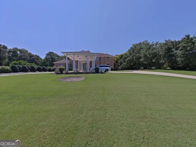 a view of a big house with a big yard