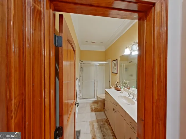a view of a hallway and a livingroom with furniture