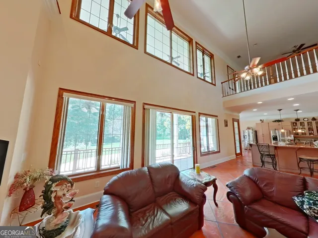 a living room with furniture fireplace and a large window