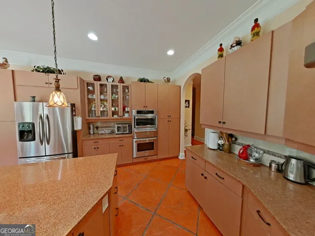 a kitchen with stainless steel appliances a refrigerator and a sink