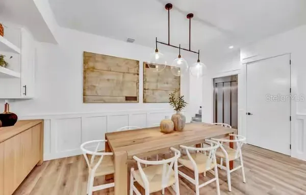 a dining room with a table and chairs
