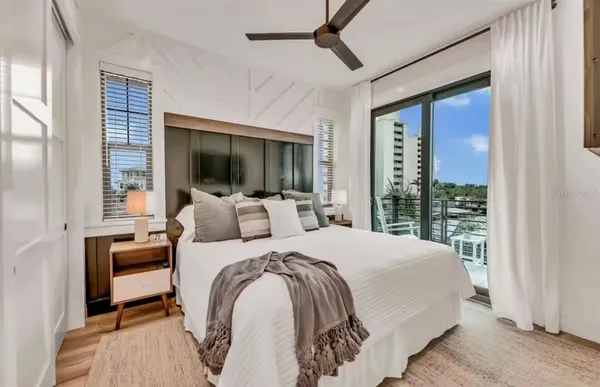 a bedroom with a bed and a large window