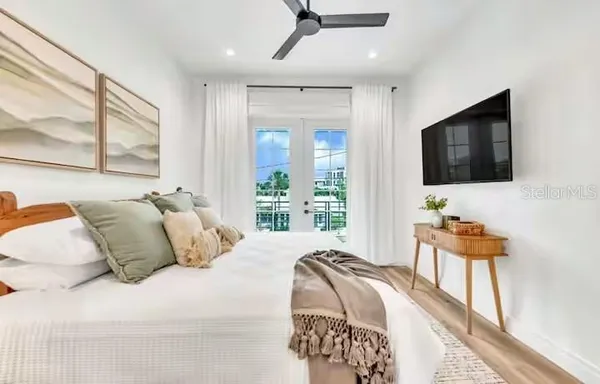a bedroom with a bed and a flat screen tv
