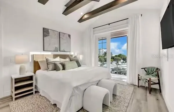 a bedroom with bed and a window