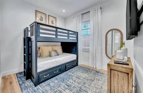 a bedroom with a bed a mirror and desk