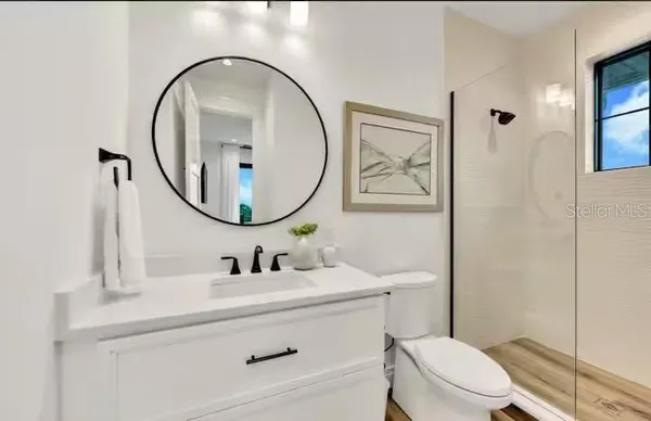 a bathroom with a toilet a sink and a mirror