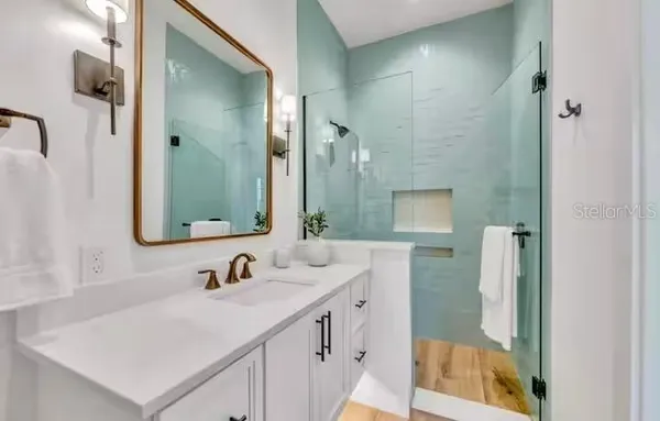 a bathroom with a double vanity sink mirror and