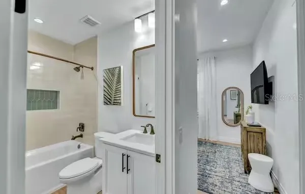 a bathroom with a toilet a sink and a mirror