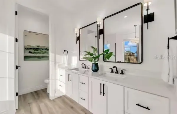 a bathroom with a double vanity sink and mirror