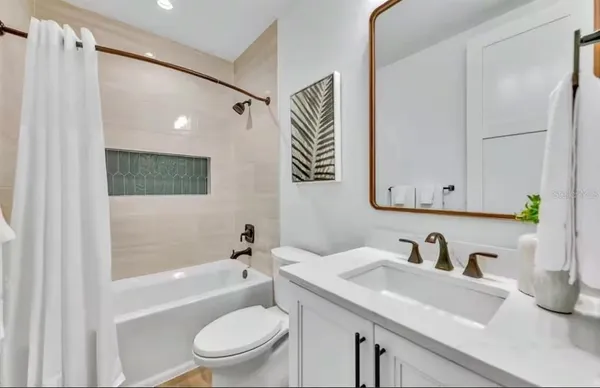 a bathroom with a sink a toilet and a bathtub