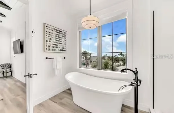 a white bath tub sitting next to a window