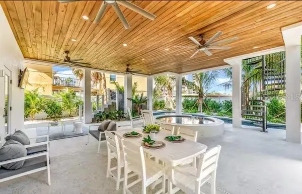 a dining room with furniture water view and balcony