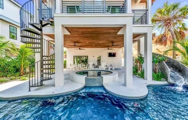 a view of a house with backyard and sitting area