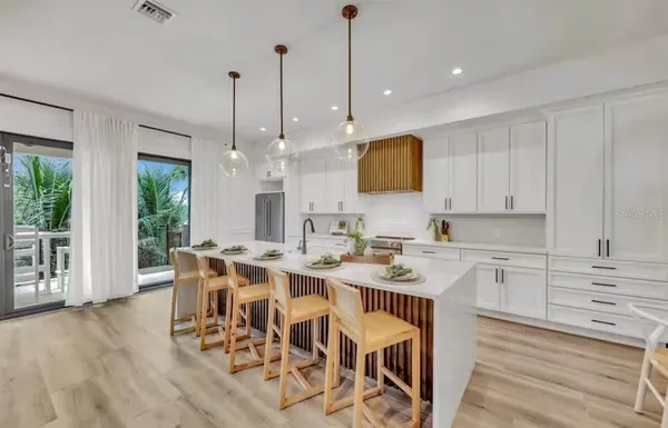 a view of dining table chairs and window