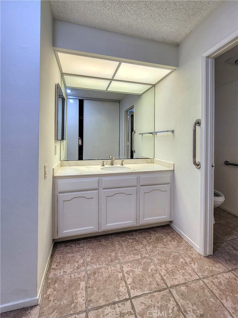 3370 Punta Alta, Unit C Laguna Woods, CA 92637 - Photo 20 of 29 a bathroom with a sink and a mirror