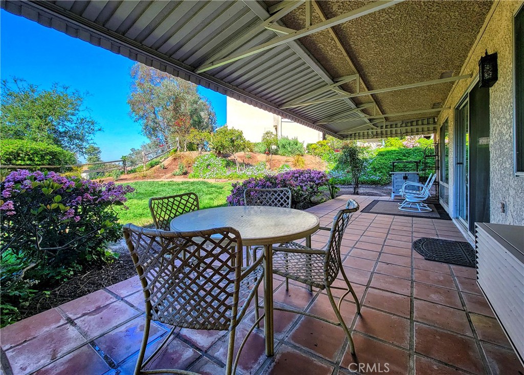 3370 Punta Alta, Unit C Laguna Woods, CA 92637 - Photo 23 of 29 a patio with an outdoor seating