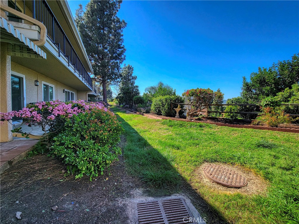 3370 Punta Alta, Unit C Laguna Woods, CA 92637 - Photo 27 of 29 a view of a chair and table in the garden