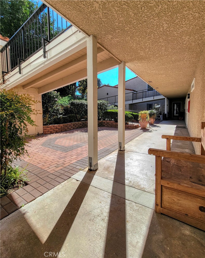 3370 Punta Alta, Unit C Laguna Woods, CA 92637 - Photo 28 of 29 a view of a patio with a table and chairs