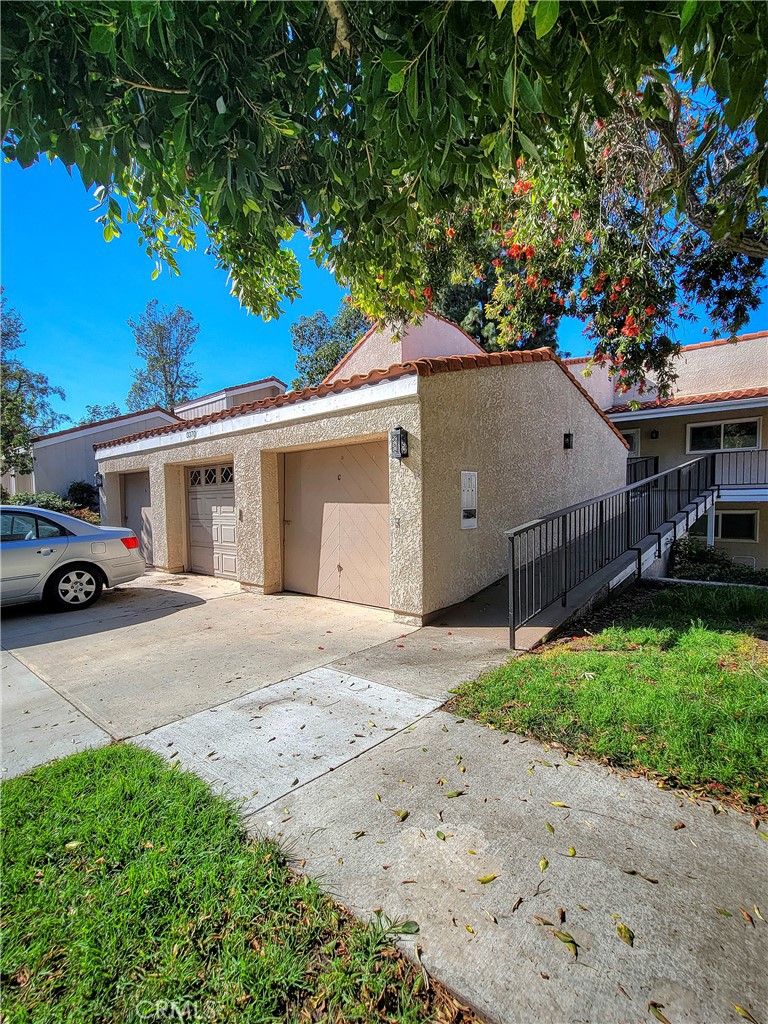 3370 Punta Alta, Unit C Laguna Woods, CA 92637 - Photo 29 of 29 a house with a tree in front of it