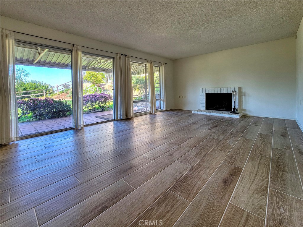 3370 Punta Alta, Unit C Laguna Woods, CA 92637 - Photo 4 of 29 wooden floor in an empty room with a window