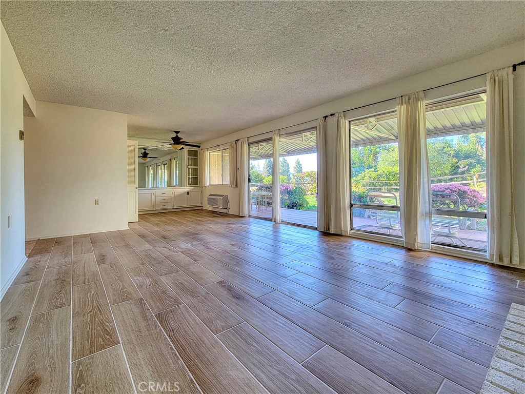 3370 Punta Alta, Unit C Laguna Woods, CA 92637 - Photo 6 of 29 a view of an empty room with wooden floor and a window