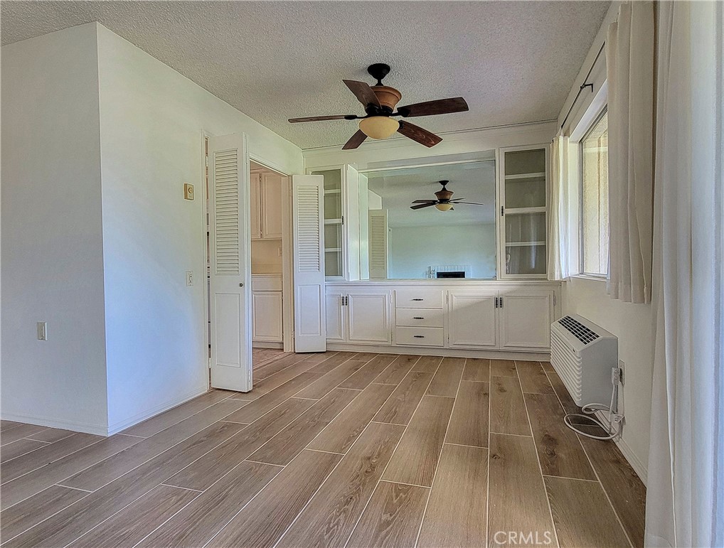 3370 Punta Alta, Unit C Laguna Woods, CA 92637 - Photo 8 of 29 a view of a big room with wooden floor and windows