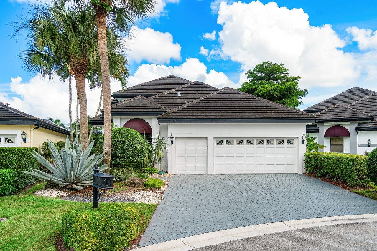 5529 Steeple Chase Boca Raton, FL 33496 - Photo 1 of 56 a front view of a house with a yard and garage