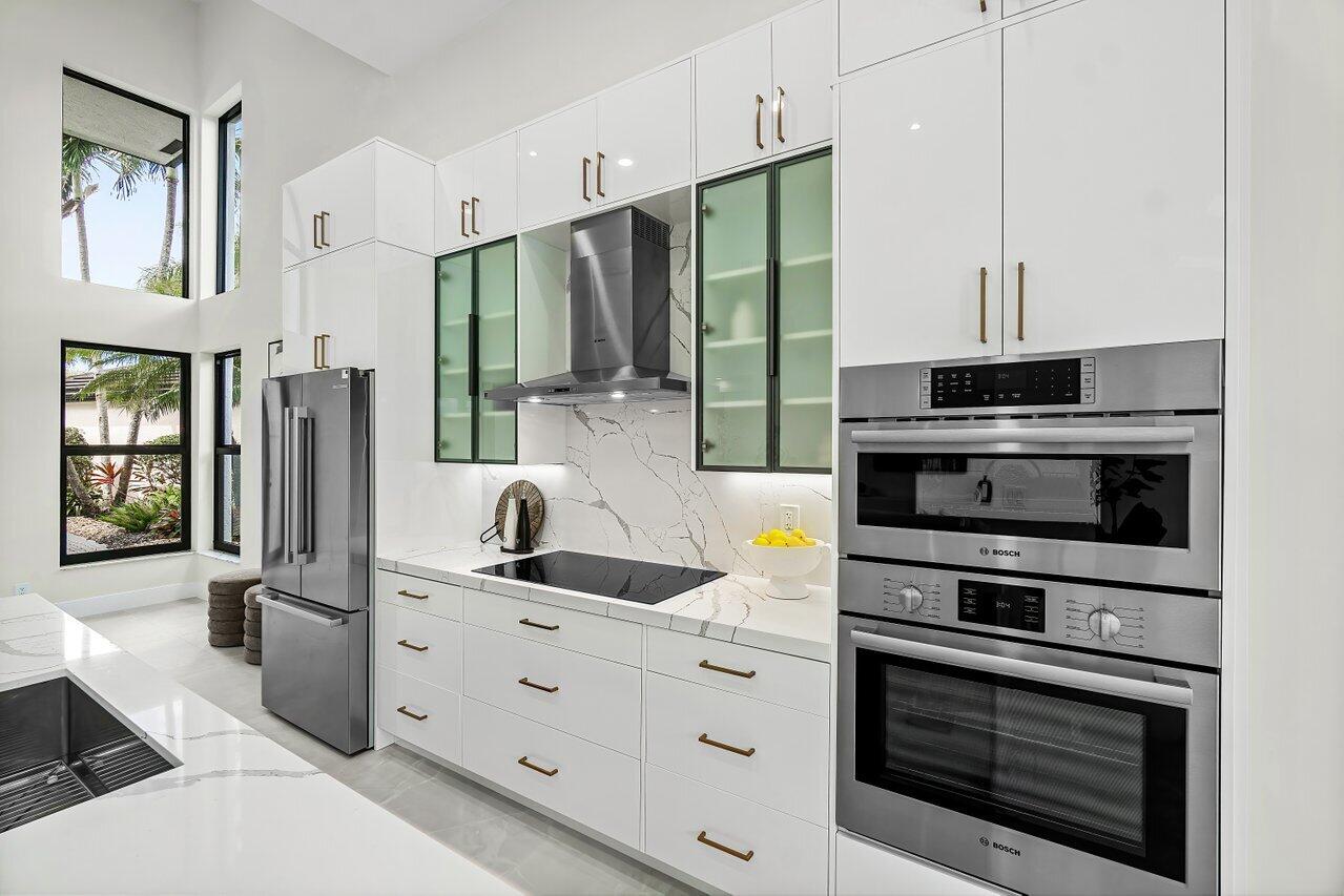 5529 Steeple Chase Boca Raton, FL 33496 - Photo 11 of 56 a kitchen with stainless steel appliances a stove a refrigerator and a sink