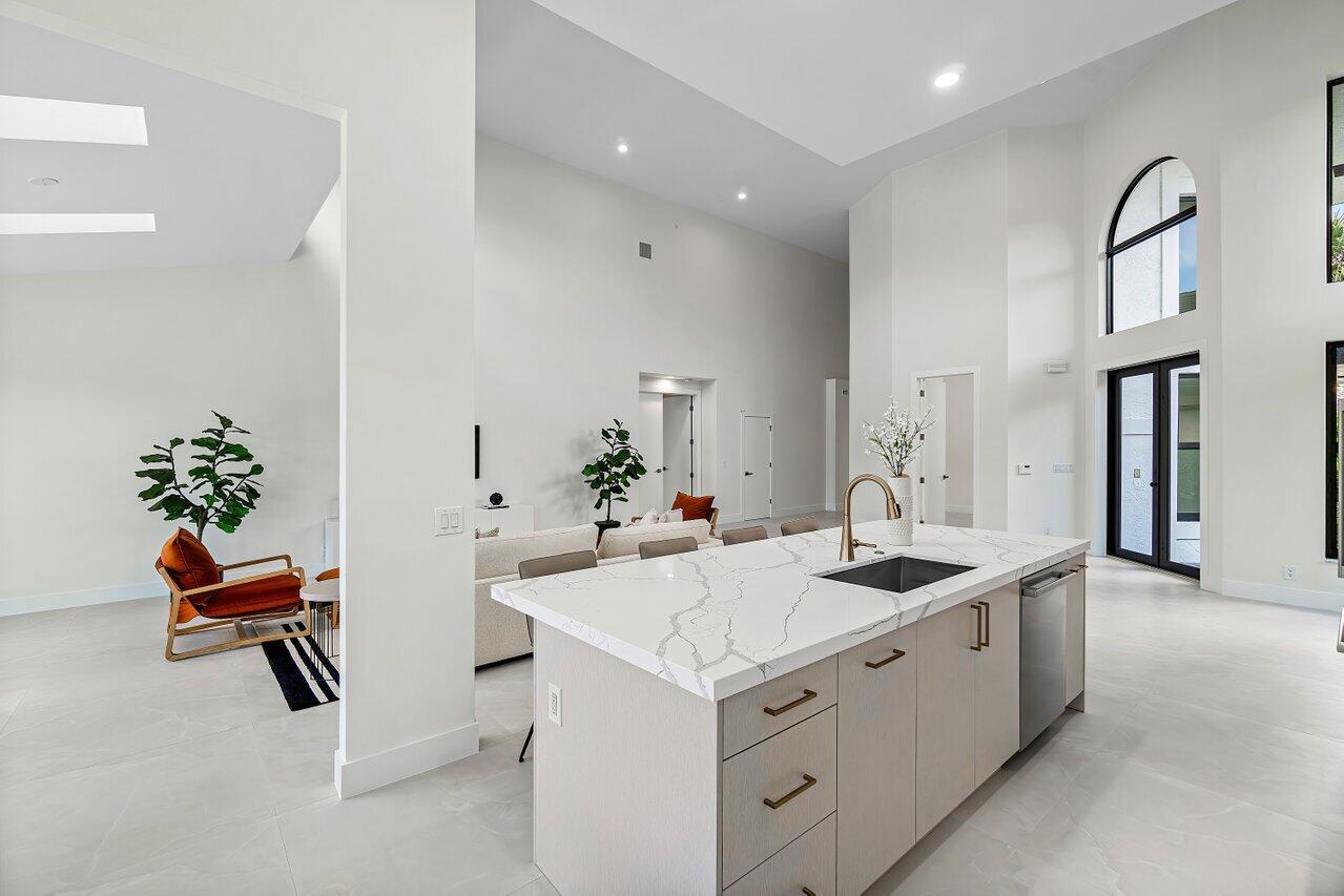 5529 Steeple Chase Boca Raton, FL 33496 - Photo 12 of 56 a kitchen that has a sink and chair
