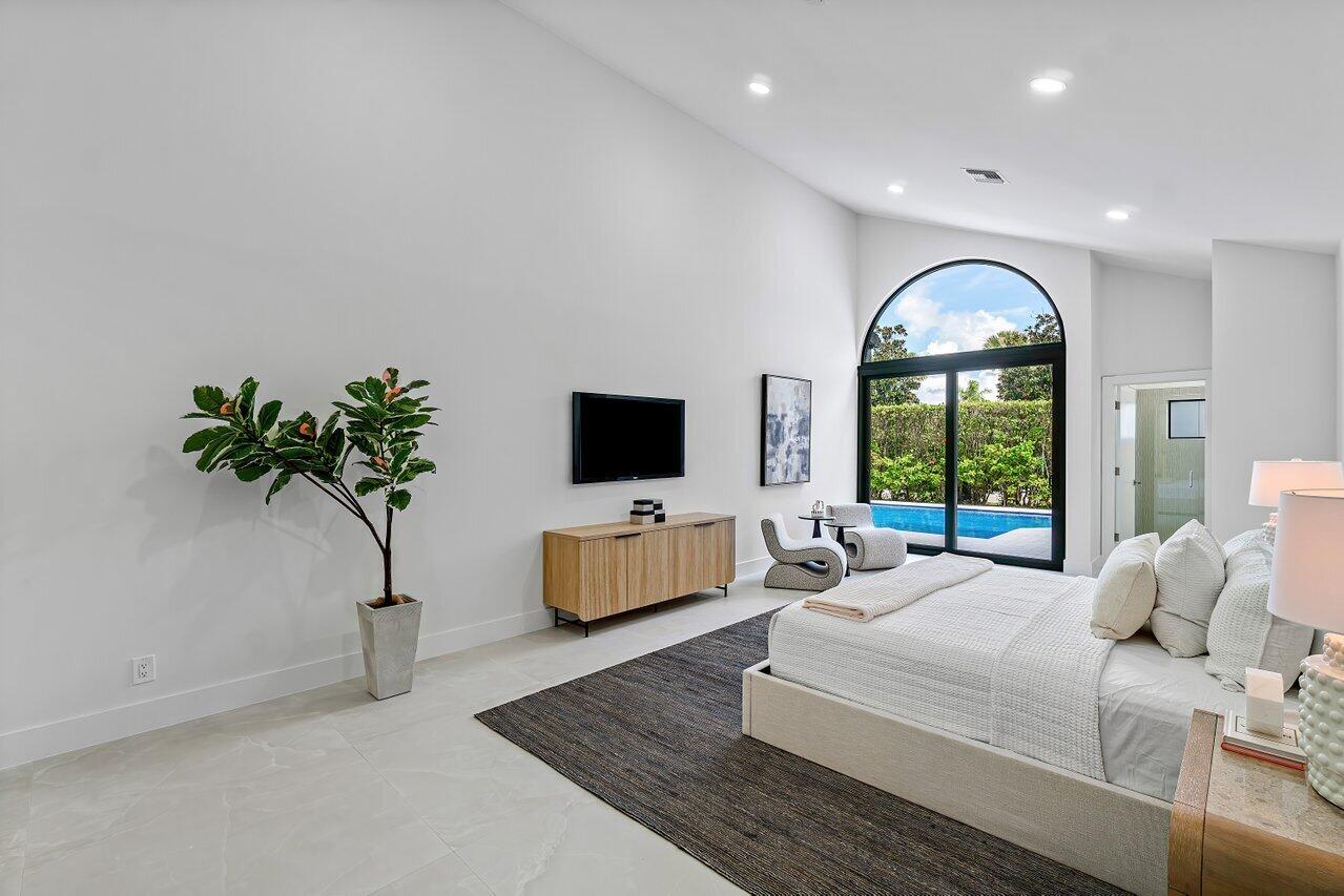 5529 Steeple Chase Boca Raton, FL 33496 - Photo 14 of 56 a bedroom with furniture and a large window