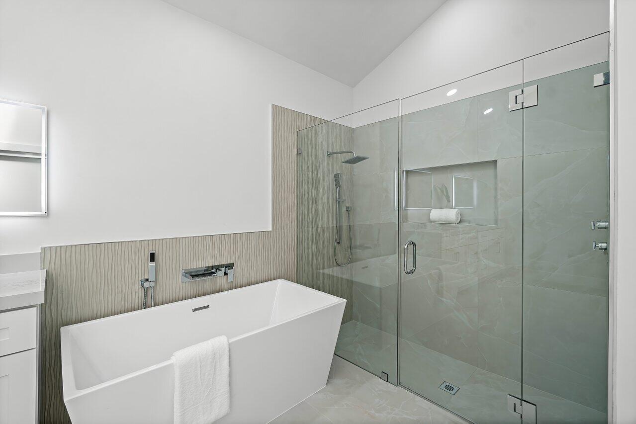 5529 Steeple Chase Boca Raton, FL 33496 - Photo 20 of 56 a bathroom with a bathtub and shower