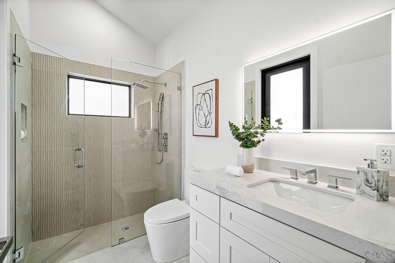 5529 Steeple Chase Boca Raton, FL 33496 - Photo 21 of 56 a bathroom with a granite countertop sink toilet and shower