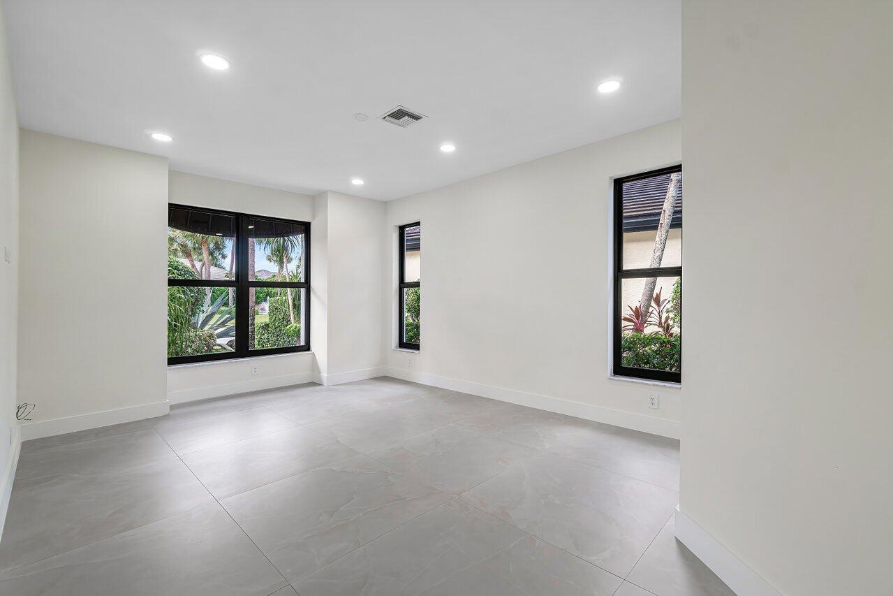 5529 Steeple Chase Boca Raton, FL 33496 - Photo 22 of 56 an empty room with windows and closet