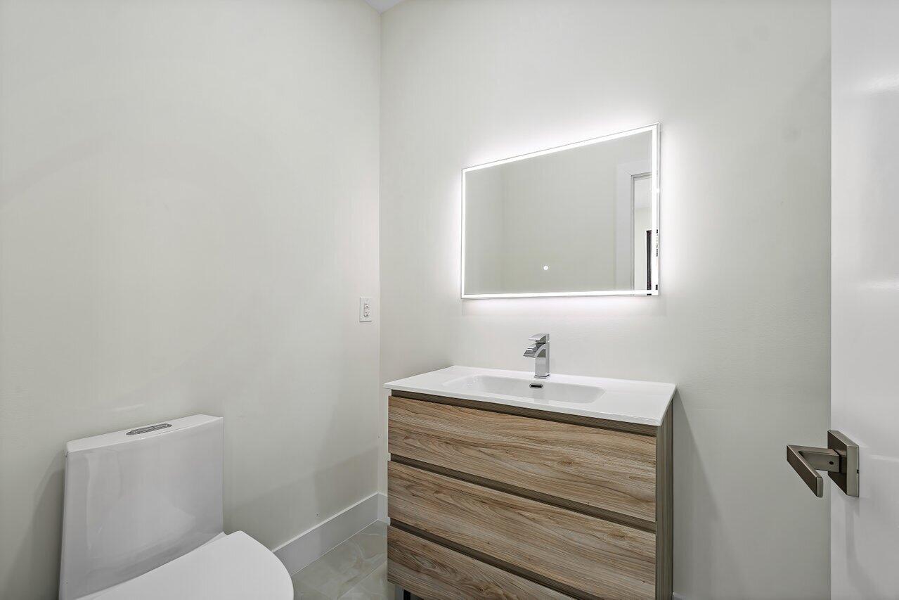 5529 Steeple Chase Boca Raton, FL 33496 - Photo 26 of 56 a bathroom with a sink toilet and mirror